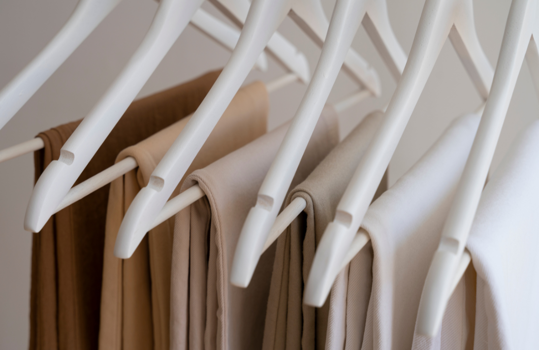 A set of clothing hangers in neutral colors