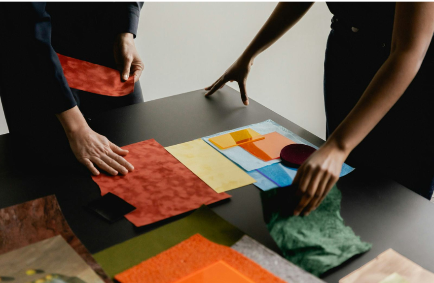 Two people selecting fabrics, textures, and colors for fashion